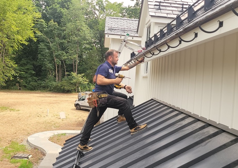 John Bayram, founder of Tri State Gutters, personally overseeing gutter installation to ensure quality workmanship