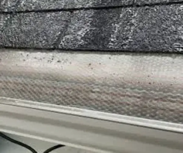 Damaged screen gutter guard - Need: 200x150px image showing bent or damaged screen guard