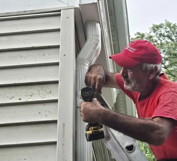 Professional installation team - Need: 600x500px image of experienced technicians installing gutters