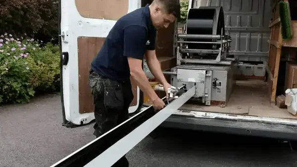 Gutter forming machine - Need: 600x400px image of seamless gutter machine in action