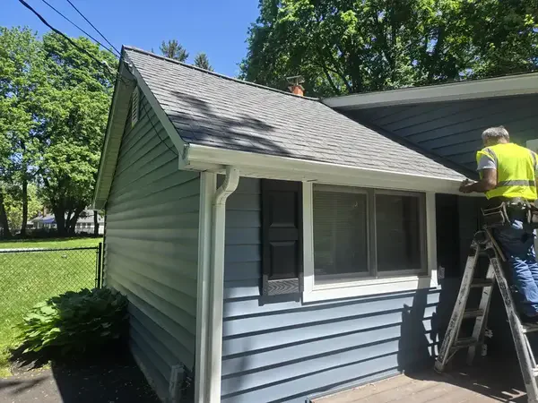 Seamless gutter installation - Need: 600x400px image of professional installation